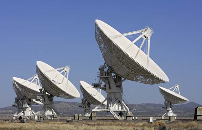 Giant radio telescopes search for extraterrestrial life.